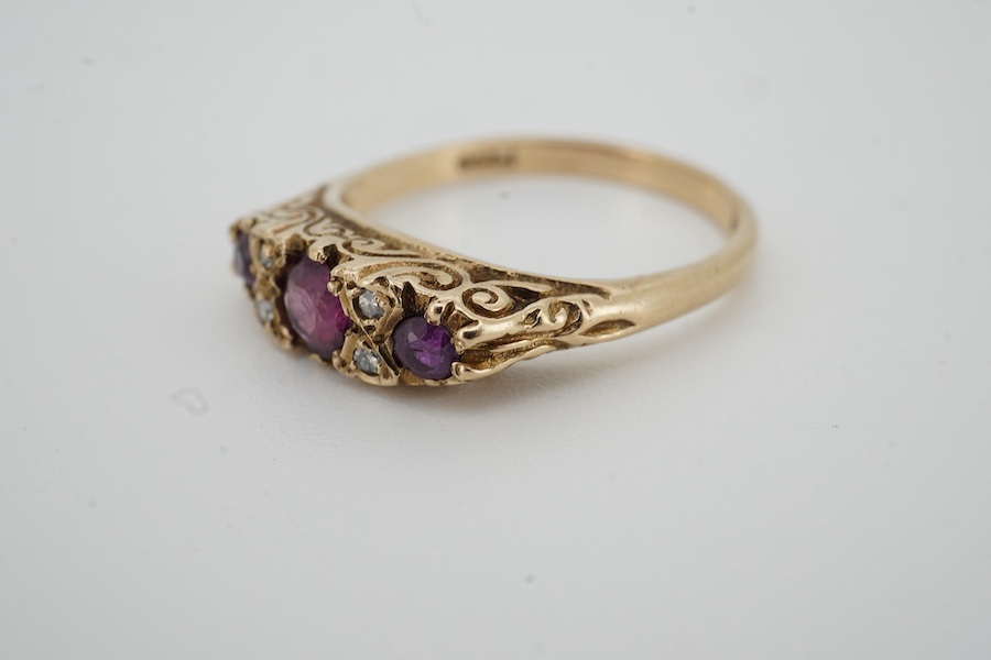 A 1960's 9ct gold ruby and diamond cluster set half hoop ring, size P, gross weight 3.1 grams.
